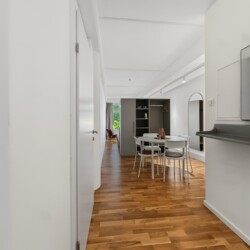 Draupromenade 12 Villach – Top 2 Gold – entrance hallway with mirror and wall console looking through to the dining and sleeping area