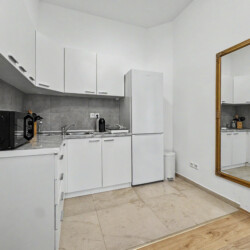 Bedroom detail with bedside table, reading lamp and laminate flooring in Vienna holiday rental