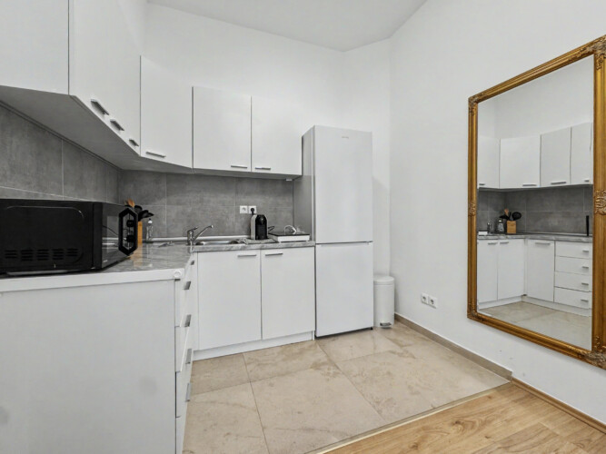 Bedroom detail with bedside table, reading lamp and laminate flooring in Vienna holiday rental