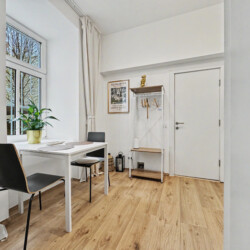 Dining area for two guests next to kitchen in Vienna Altbau ground floor apartment