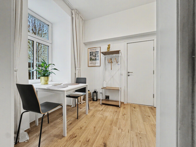 Dining area for two guests next to kitchen in Vienna Altbau ground floor apartment