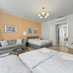 Large dining table set for nine guests in open-plan Vienna Altbau apartment