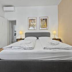 Bedroom detail with bedside lamp and parquet flooring in elegant Vienna holiday rental