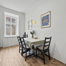 Cozy double bed with decorative pillows in second bedroom of Vienna Altbau apartment