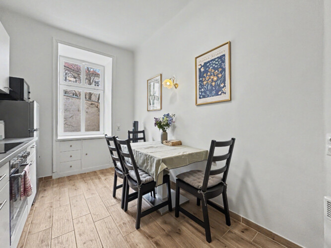 Cozy double bed with decorative pillows in second bedroom of Vienna Altbau apartment