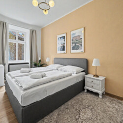 Third bedroom detail with reading lamp and warm lighting in Vienna short-term rental