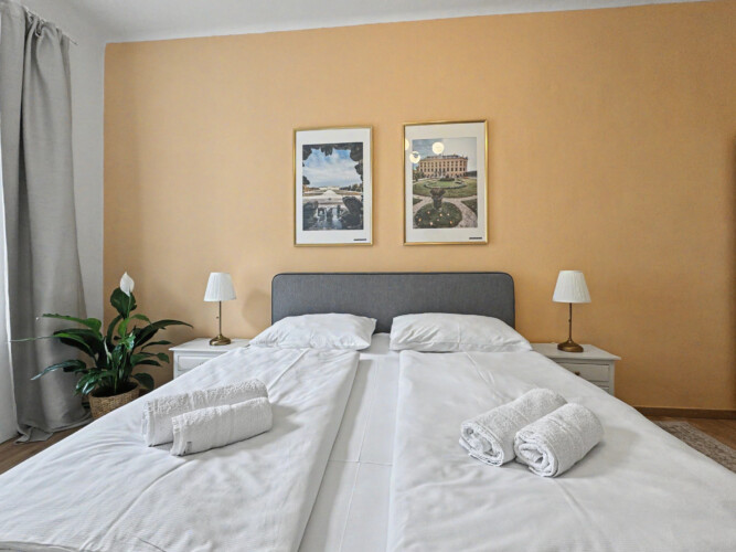 Sofa bed in living area providing extra sleeping space in Vienna Altbau group apartment