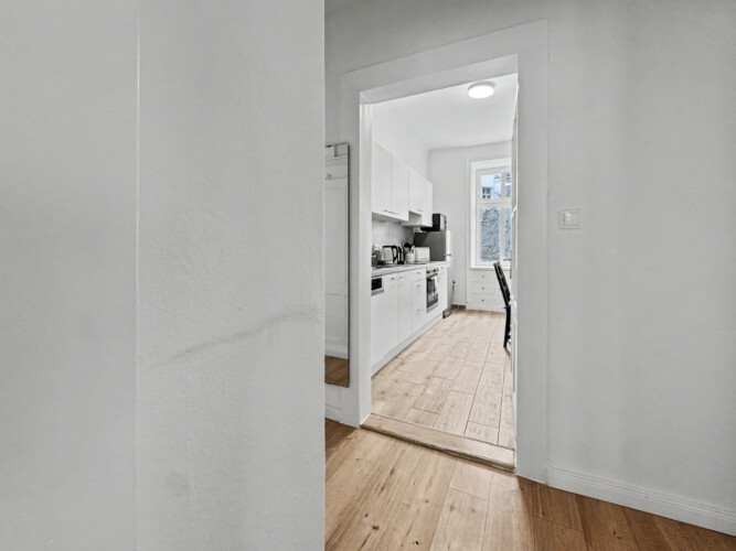 Bathroom with bathtub and checkerboard floor tiles in Vienna Altbau apartment