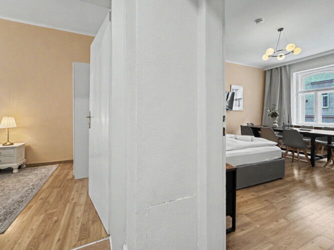 Bathtub detail and shower fixtures in classic Vienna Altbau apartment bathroom
